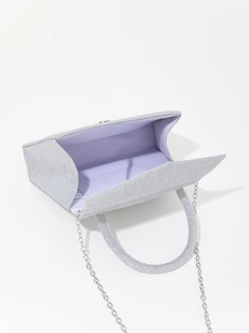 Detail view of silver glitter evening bag with purple satin lining and metal chain strap