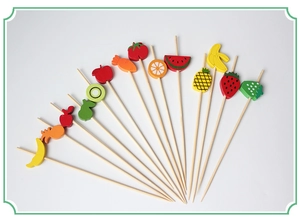 Detailed top view of bamboo fruit picks with colorful pineapple and strawberry toppers
