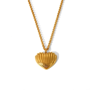 Close-up of golden heart pendant with shell texture on a delicate rolo chain necklace