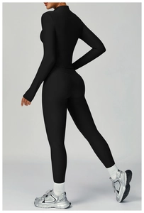 Close-up of black ribbed long-sleeve crop top and high-waist seamless yoga leggings