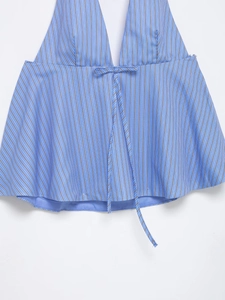Detail of blue and white striped halter top featuring a front bow tie and shirt fabric