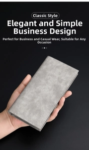Close-up of minimalist grey matte leather wallet with premium stitching held by hand