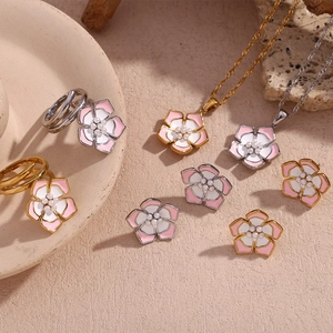 Detail of 18K gold plated cherry blossom jewelry set with pearls and enamel petals