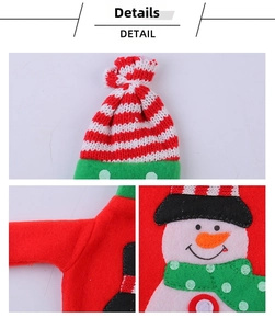 Detail of Christmas wine bottle cover with snowman embroidery and red striped knit texture