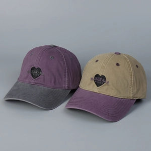 Detail of washed cotton baseball caps with heart embroidery and contrast color design
