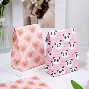 Detail of pink mini paper gift bags with cute bear and panda designs for packaging