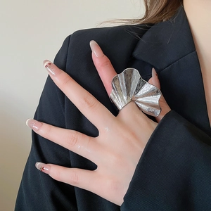 Macro detail of textured ginkgo leaf silver metal ring with pleated surface finish