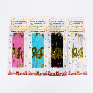 Detail of four colorful fringe curtains with gold Feliz Cumpleaños lettering for birthday party