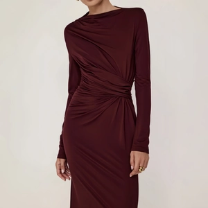 Detail of elegant ruched fabric and slim fit design on this burgundy long sleeve dress