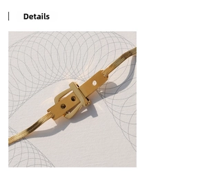 Detailed close-up of golden belt buckle clasp on a flat snake chain bracelet