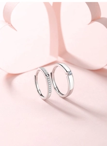 Macro shot of silver S925 sterling silver couple rings with cubic zirconia details