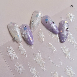 Detail of purple gradient nails with white butterfly patterns and sparkling rhinestones