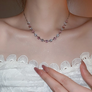 Detail view of pink zircon pendant necklace with sparkling gems and metallic chain