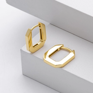 Macro shot of S925 sterling silver stamp on the polished gold square geometric earring