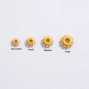 Detailed size comparison of golden flower spacer beads in XS, S, M, and L dimensions