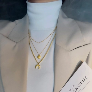 Three-layer gold titanium steel necklace with star and moon crescent pendants on model