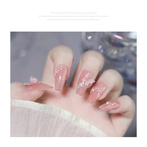 Pink gradient long coffin press-on nails with 3D butterfly, pearls, and glitter