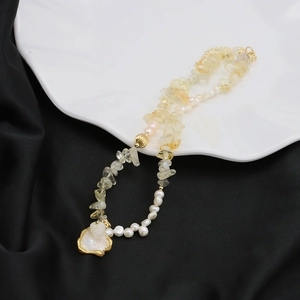 Baroque freshwater pearl and citrine beaded necklace with shell pendant on black fabric
