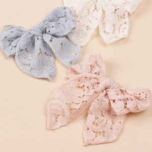 Set of three lace bow hair clips in light blue, off-white, and pink for girls