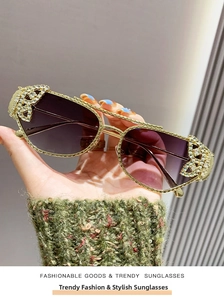 Detail of luxury sunglasses with gold metal frame, purple gradient lenses and rhinestones