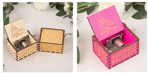 Detail of vintage wooden hand-cranked music boxes with Happy Birthday engraving