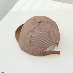 Detail of baby sun hat with breathable brown mesh fabric and adjustable velcro strap