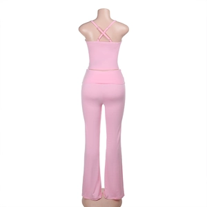 Detail of the pink two-piece set featuring a crisscross back camisole and flared trousers