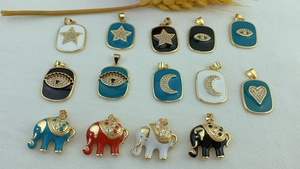 Flat lay of colorful enamel elephant and heart charms with sparkling rhinestones