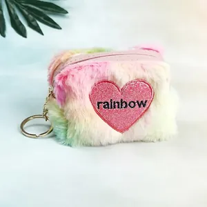 Detailed macro view of soft gradient plush coin purse with heart embroidery and key ring