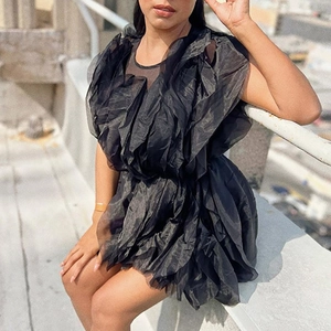 Detailed close-up of a black sleeveless dress with layered ruffled mesh and organza tiers
