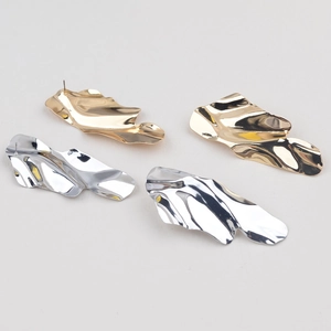 Detailed close-up showing gold and silver irregular pleated metallic geometric stud earrings