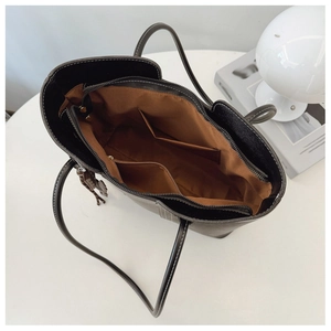 Top view of large tote bag showing brown lining, inner pockets and zipper closure