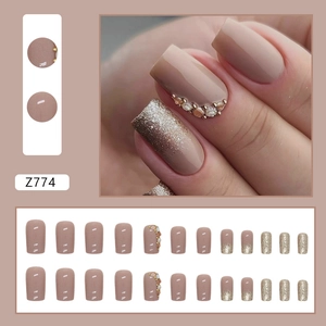 Sparkling nude glitter press-on nails with rhinestone accents in square-oval shape