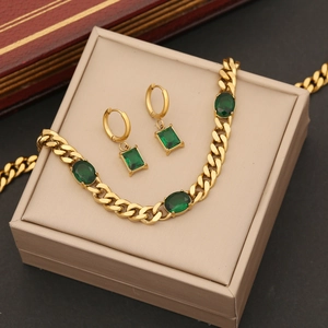 Golden stainless steel jewelry set with emerald green stones in a beige gift box