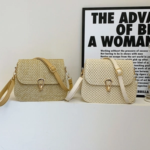 Minimalist woven straw crossbody bags in brown and white with gold teardrop metal clasps