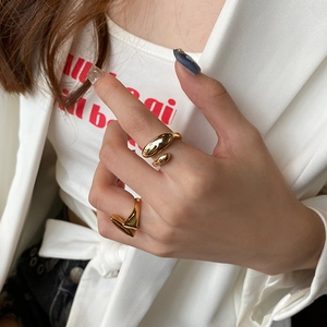French style gold plated irregular adjustable open rings worn by a model in a minimalist suit