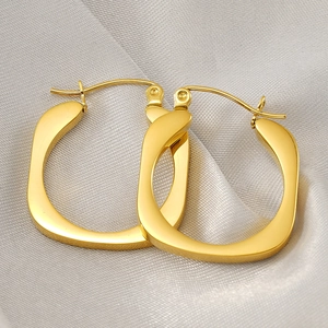 Elegant 18k gold plated stainless steel rectangle hoop earrings on beige silk fabric background