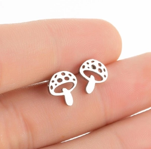 Detailed close-up of silver mushroom stud earrings with minimalist hollow dots design