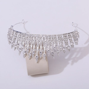 Elegant silver bridal crown with cascading rhinestones and crystals on a display stand