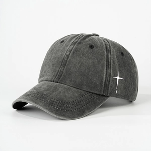 Detail view of washed cotton baseball cap featuring side white star print and vintage texture