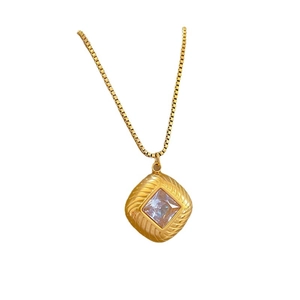 Minimalist gold titanium necklace with square zircon pendant and box chain on white background