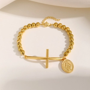 Elegant gold stainless steel beaded bracelet featuring cross and oval religious charm