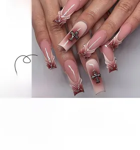 Detail of 3D metallic cross charms on French gradient mauve press-on nails set