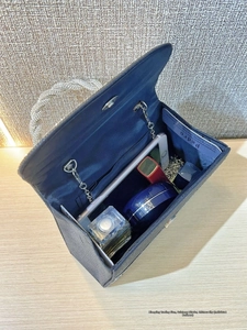 Internal view of navy blue evening clutch showing space for phone, lipstick and perfume