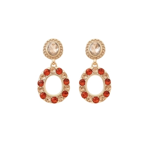 Orecchini vintage dorati con gemme color champagne e strass arancioni in design geometrico