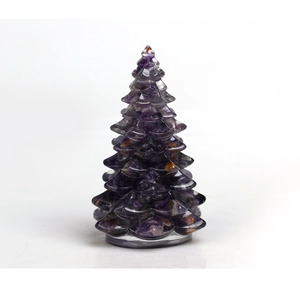 Detail of amethyst crystal Christmas tree figurine with natural purple stone texture