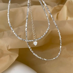 Elegant S925 silver plated irregular bead necklace with heart charm on kraft paper