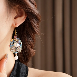 Macro detail of vintage enamel flower earrings with pearls and pink gems on model