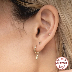 S925 sterling silver huggie earrings set with heart studs and purple stone on model