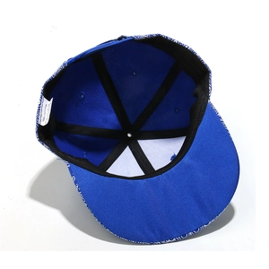 Detail view of cotton snapback hat interior showing paisley pattern and blue buckle strap